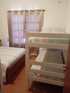 two bunk beds in a room with a window at La Tranquila in Fernández