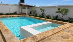 a swimming pool in the middle of a house at Zanziland Apartments in Kiwengwa