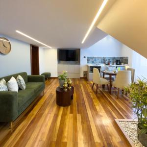 a living room with a couch and a table at Arbórea Casa Boutique in Cuenca