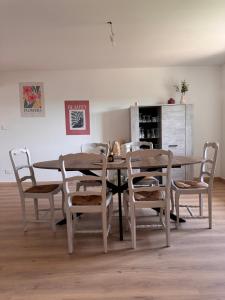 a dining room with a wooden table and chairs at Gîte la Tinou in Saint-Nabord