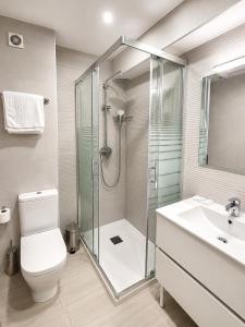 a bathroom with a shower and a toilet and a sink at Hostal Goyma I in San Fernando de Henares +6 photos