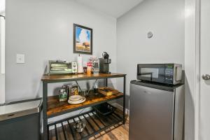 a kitchen with a counter with a microwave and a refrigerator at Cabot Modern Pet Friendly Apt 2nd Floor Studio in Whitefield