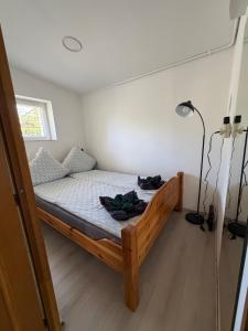 a bedroom with a wooden bed in a room at Mancs&Buborék Kutyabarát Vendégház in Komló