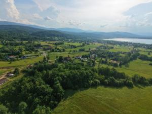 an aerial view of a farm with a lake at Pine Peak Holiday House Sosnówka in Sosnówka +20 photos