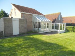 a extension to a house with a lawn at Bungalow in Breskens near Beach and Lighthouse in Breskens