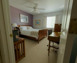 a bedroom with a bed and a desk and a chair at Lawrence Loft in Lawrence