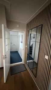 a room with a hallway with a mirror and a door at Keflavik Heart in Keflavík