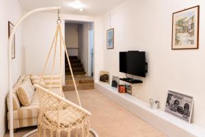 a living room with a swing and a tv at Apartman San in Mostar