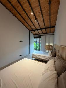 a large room with two beds and a window at CASALIA Sopetran in Sopetrán +68 photos