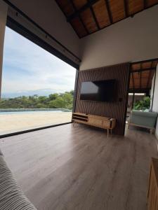 a large living room with a flat screen tv at CASALIA Sopetran in Sopetrán