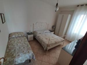 a bedroom with two beds in a room at The sisters apartment in Punta Marina
