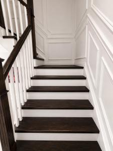 a staircase with white walls and wooden railings at The Quiet Nest in Mississauga +3 photos