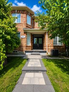 a brick house with a walkway in front of it at The Quiet Nest in Mississauga