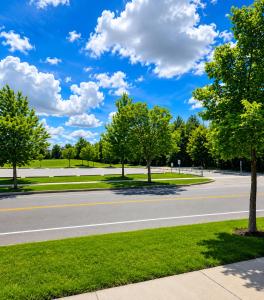 an empty road with trees on the side of the road at The Quiet Nest in Mississauga