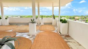 a balcony with a row of tables and plants at Zanziland Apartments in Kiwengwa