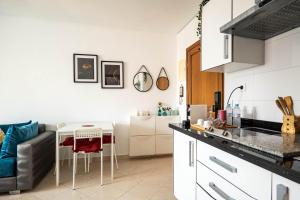 a kitchen and living room with a couch and a table at Brisa Marina Cabo in Cabo Negro