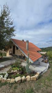 a house with an orange roof and a patio at Nebeska Terasa in Knić