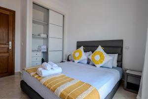 a bedroom with a bed with two towels on it at Brisa Marina Cabo in Cabo Negro +9 photos