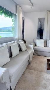a living room with a couch and a large window at Cabanas da Auga A in A Telleira