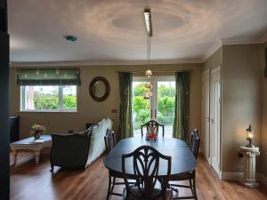 a dining room with a blue table and chairs at Sheiling Accommodation in Castlemartyr