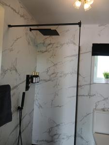 a bathroom with a white marble wall at Sheiling Accommodation in Castlemartyr +36 photos