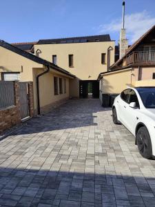 a white car parked in front of a building at Apartmán na Břehách in Veselí nad Moravou