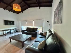 a living room with a couch and a table at MARESIA Skate House in Chapadmalal
