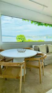 a living room with a table and chairs and a couch at Cabanas da Auga B in Casas Novas