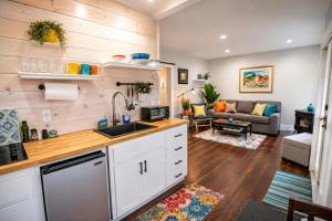 a kitchen and living room in a tiny house at Seaside Saloon Hot Tub Getaway in Sequim