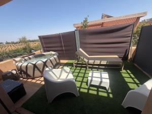a patio with couches and chairs on the grass at Villa familiale a 10km du boulevard Mohamed VI in Marrakesh