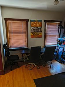 a room with three chairs and a table and two windows at Briugu's Bunkhouse in Denver