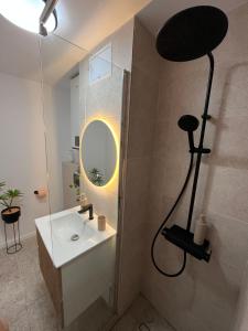 a bathroom with a shower and a white sink at Lena Apartment in Calafat +15 photos