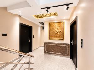 a hallway with two doors and a painting on the wall at The Bay Suites - NIS in kolkata