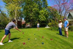 a group of people playing with balls in a yard at The Sanctuary on Washington in Norwich