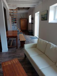 a living room with a couch and a table at Les Marronniers Roses in Châteaulin