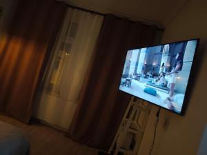a flat screen tv in a room with a window at 1904 Studio in Świnoujście