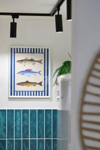 a kitchen with a picture of fish on the wall at Villa Balaton in Balatonmáriafürdő +29 photos