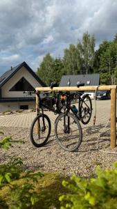 a bike is parked in front of a house at Domki na Stronie C in Stronie Śląskie