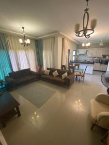 a living room with a couch and a table at Plage Mountain View in El Alamein