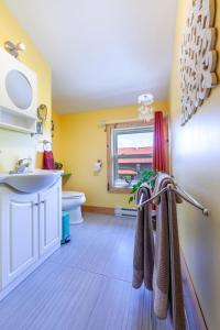a bathroom with a sink and a toilet and a window at Spa Stukely in Eastman