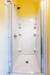 a bathroom with a shower with a glass door at Spa Stukely in Eastman +12 photos