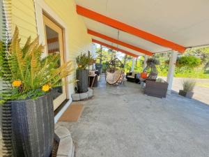 a porch of a house with plants on it at Tide Pool Cabin, a Soquinomere Private Hotel on the Dunes, Downtown Ocean Shores in Ocean Shores