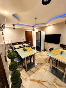 a dining room with tables and a tv on the wall at Fadars Place in Sagisa