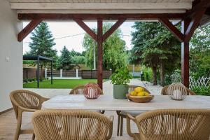 a table with a bowl of fruit on a patio at Villa Balaton in Balatonmáriafürdő