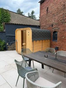 a patio with a table and chairs and a building at Altes Lehmhaus Löwenberg in Linde +37 photos