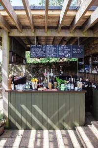 a bar in a building with a wooden roof at The Ebrington Arms in Chipping Campden