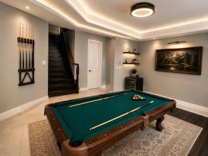 a living room with a pool table and a staircase at Gifted Beautiful Home in Brampton