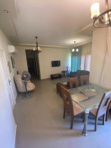 a living room with a table and chairs and a couch at Plage Mountain View in El Alamein
