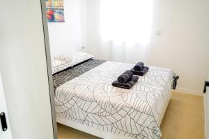 a bedroom with a bed with towels on it at Luxury Apartment Mara in Sukošan