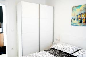 a bedroom with a bed and a mirror at Luxury Apartment Mara in Sukošan